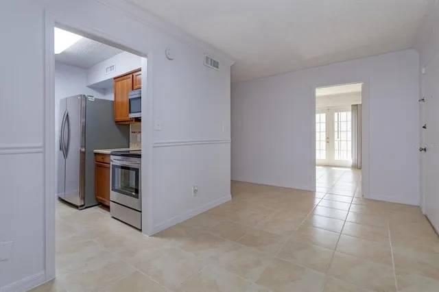 a view of kitchen with furniture and stainless steel appliances