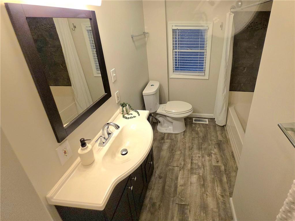 5232 Keystone Street Pittsburgh, PA 15201 - Photo 13 of 48 a bathroom with a sink a toilet and mirror