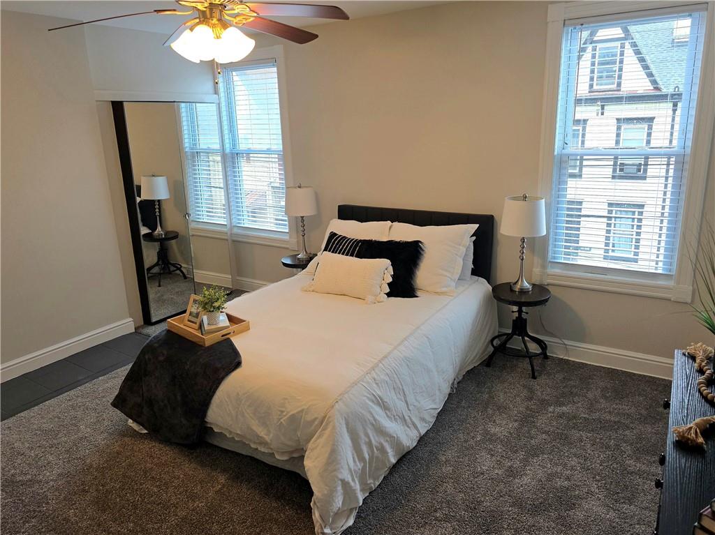 5232 Keystone Street Pittsburgh, PA 15201 - Photo 31 of 48 a bed sitting in a bedroom next to a window