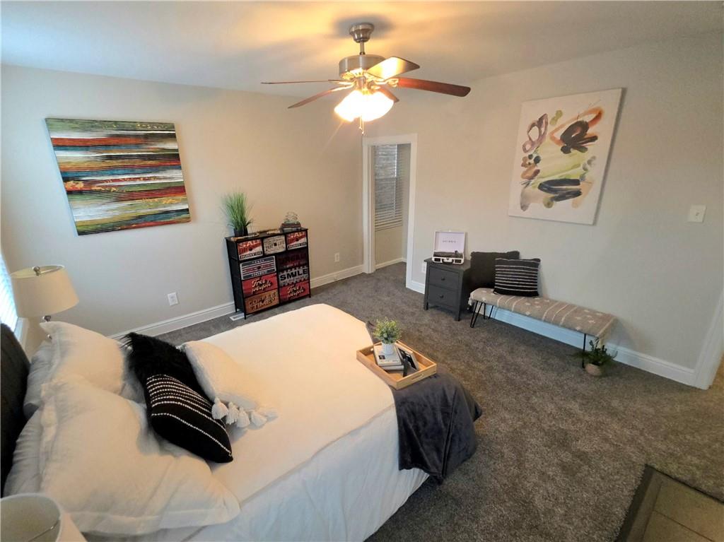 5232 Keystone Street Pittsburgh, PA 15201 - Photo 32 of 48 a bedroom with a bed and a chandelier