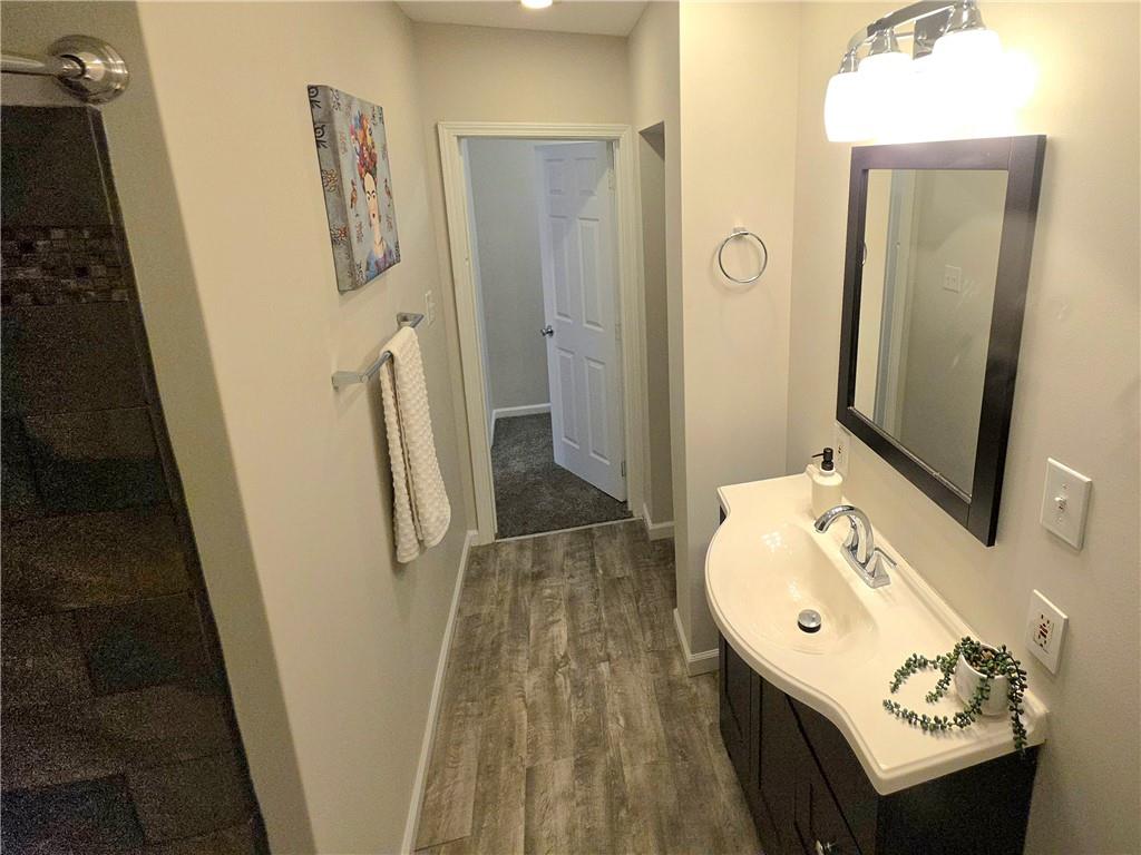 5232 Keystone Street Pittsburgh, PA 15201 - Photo 37 of 48 a bathroom with a sink a mirror and a shower