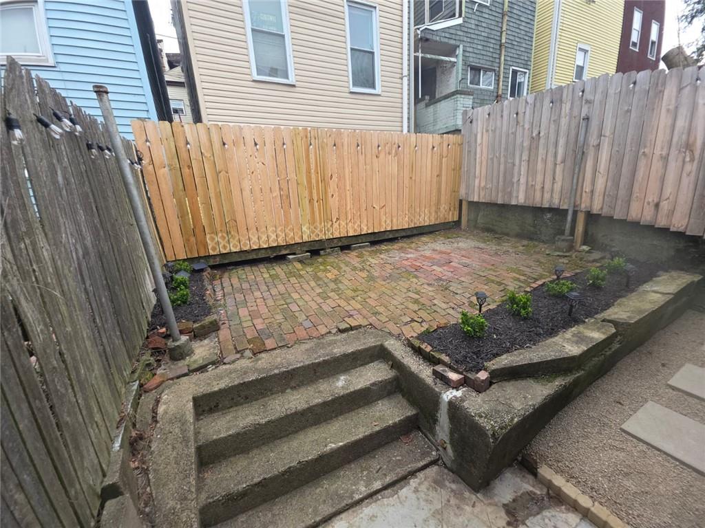 5232 Keystone Street Pittsburgh, PA 15201 - Photo 45 of 48 a view of a backyard with wooden fence