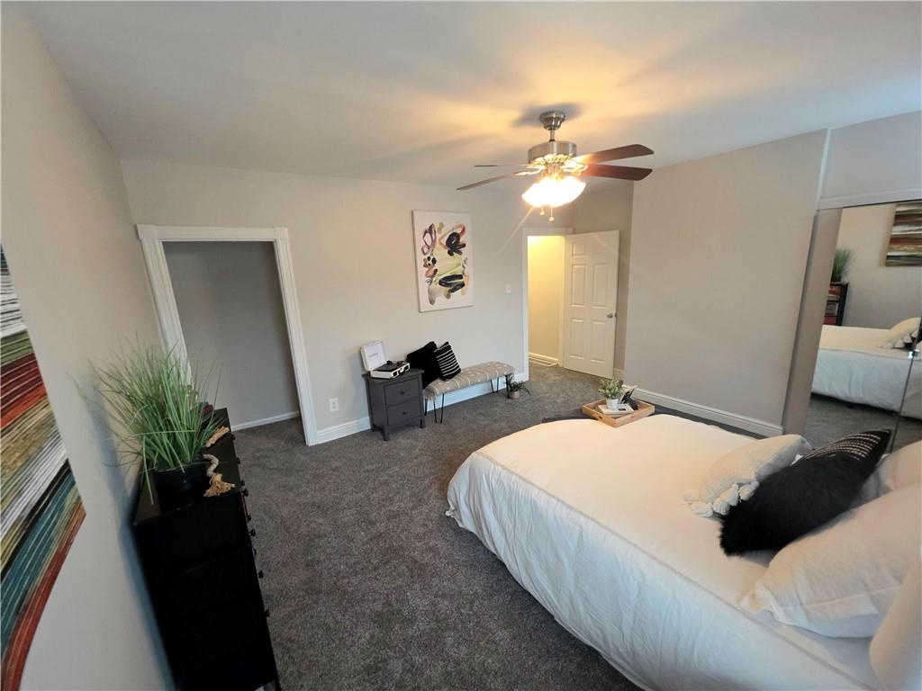 5232 Keystone Street Pittsburgh, PA 15201 - Photo 10 of 48 a bedroom with a bed and a chandelier