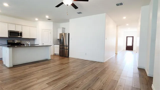 a kitchen with stainless steel appliances a refrigerator and a stove top oven