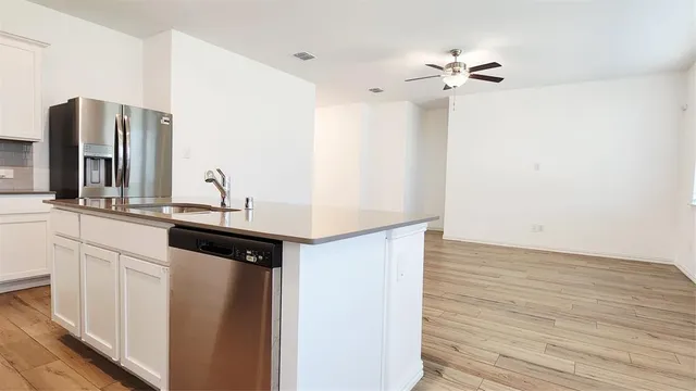 a kitchen with a sink and a refrigerator