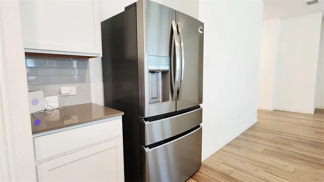 a kitchen with a refrigerator and cabinets