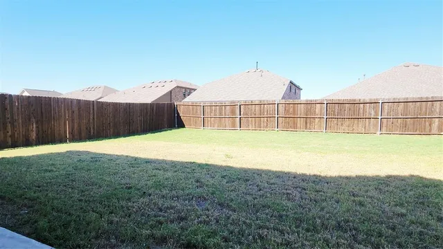 a view of a backyard with a swimming pool