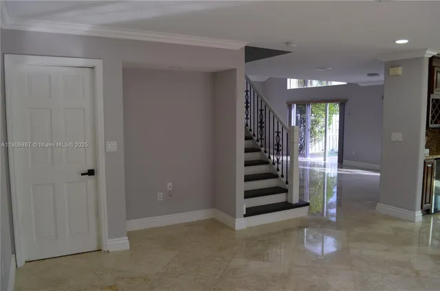 a view of a hallway with stairs