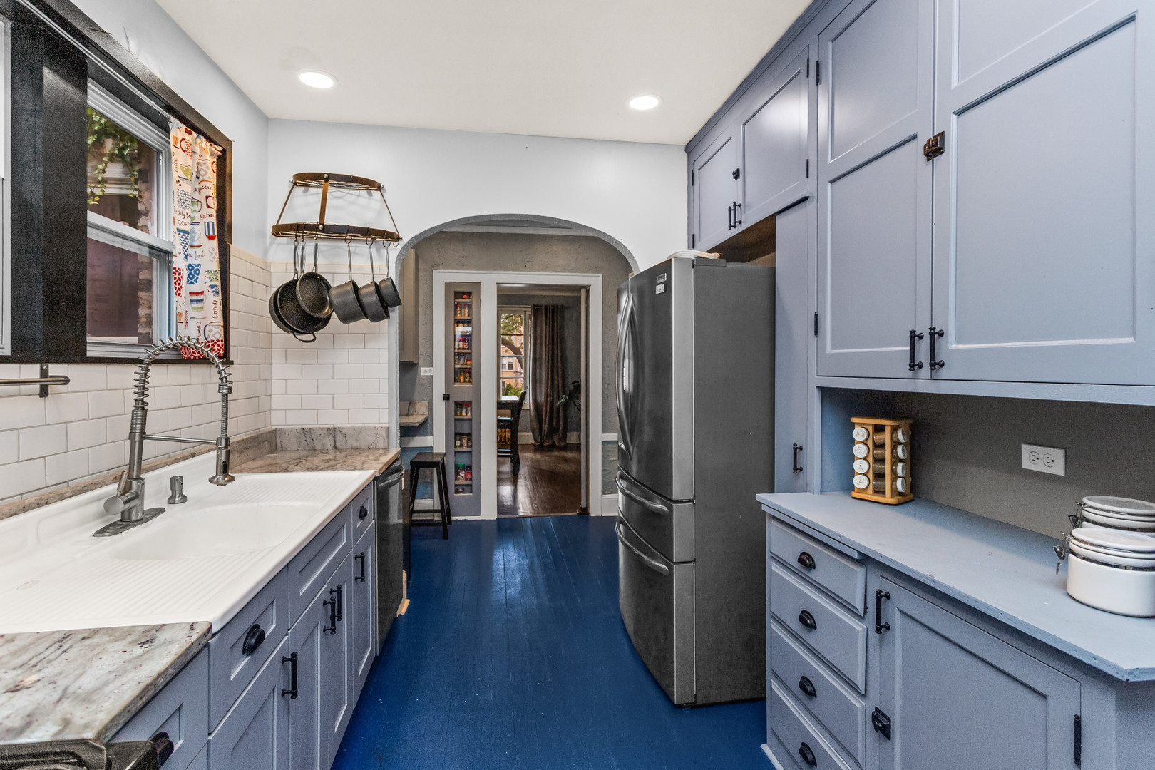 7523 North Seeley Avenue, Unit 1 Chicago, IL 60645 - Photo 11 of 18 a kitchen with stainless steel appliances a sink stove and refrigerator