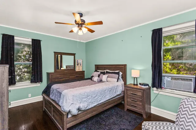 a bedroom with a large bed and a window