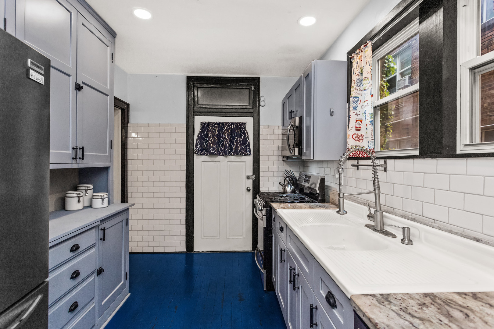 7523 North Seeley Avenue, Unit 1 Chicago, IL 60645 - Photo 10 of 18 a kitchen with a sink stove and refrigerator