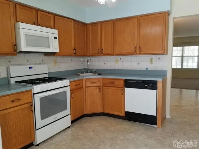 a kitchen with granite countertop cabinets stainless steel appliances and a sink