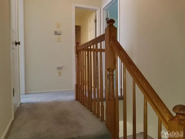 a view of a hallway with wooden floor and entryway