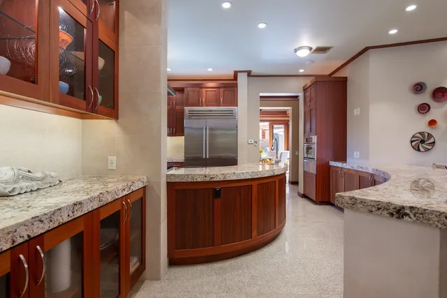 a kitchen with granite countertop a sink stove and cabinets