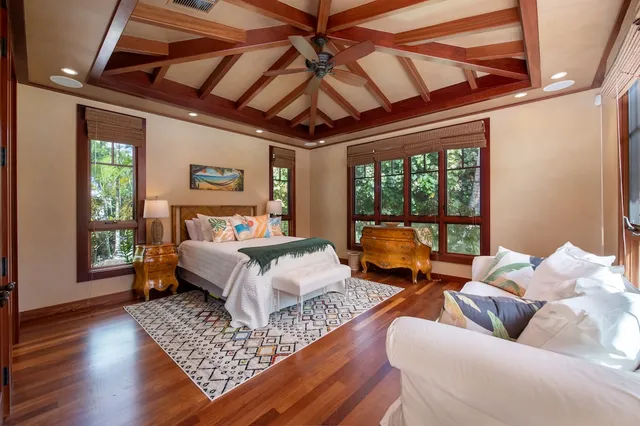 a bedroom with furniture and a large window