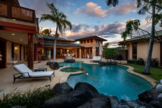 a view of a house with swimming pool patio and a yard