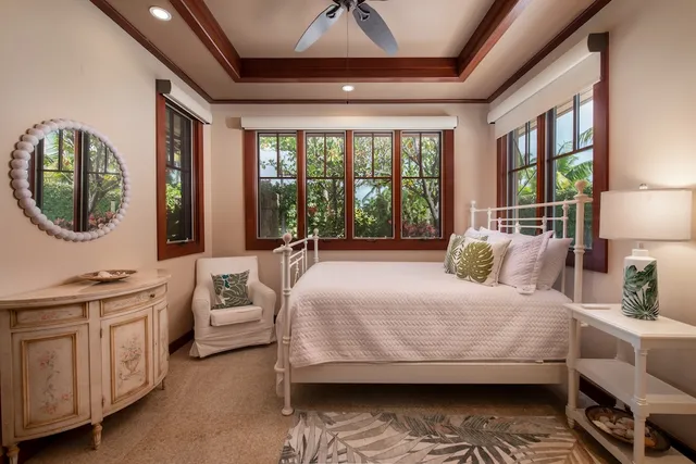 a bedroom with a large bed and a chandelier
