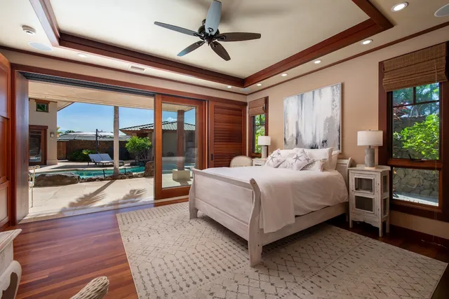 a bedroom with a large bed and a chandelier