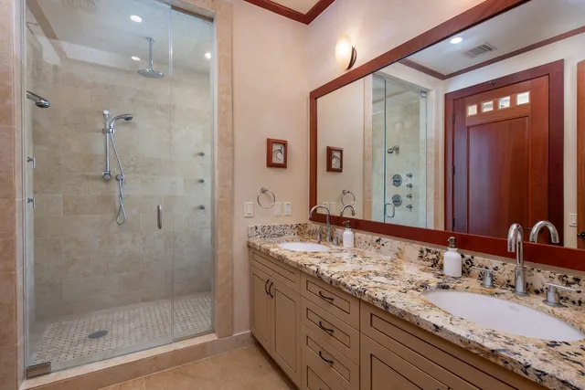 a bathroom with a granite countertop sink mirror and double