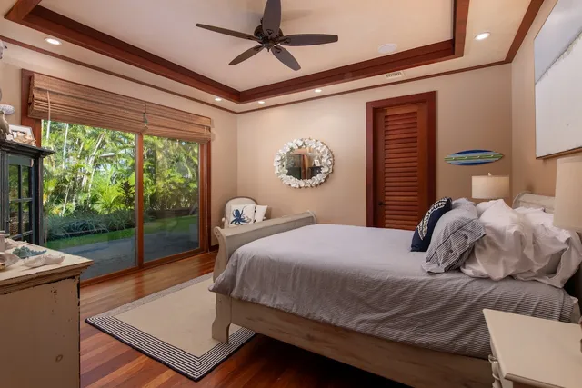 a bedroom with a bed and large window