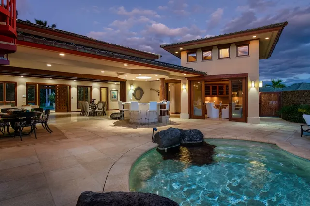 a swimming pool in front of the house