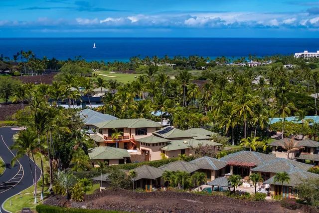 a view of a patio with lawn chairs under an umbrella