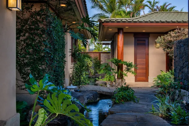 a front view of a house with plants