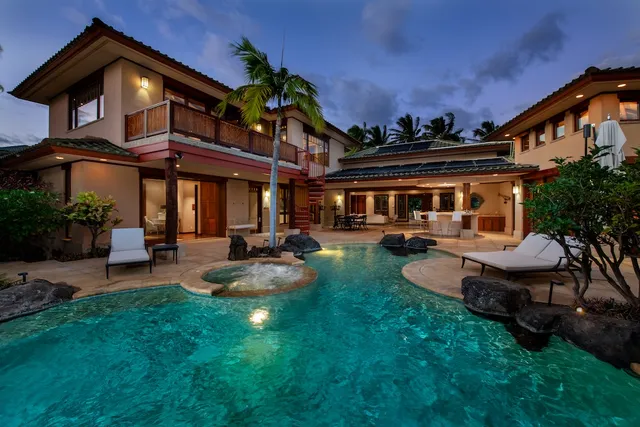 a view of a house with backyard porch and sitting area
