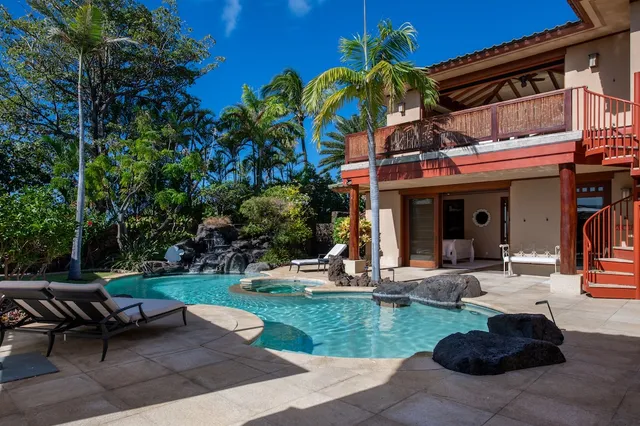 a view of a house with backyard sitting area and garden