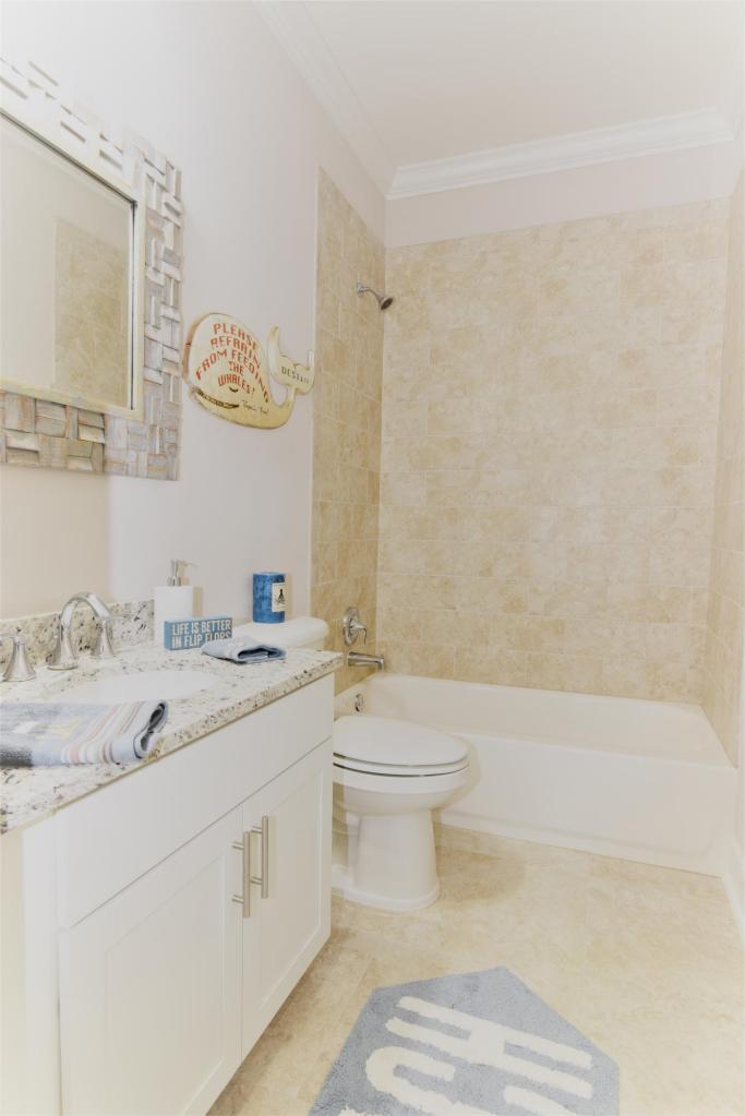257 Driftwood Road, Unit 2 Miramar Beach, FL 32550 - Photo 22 of 41 a bathroom with a granite countertop sink a toilet and a bathtub