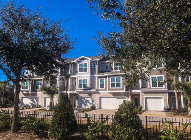 257 Driftwood Road, Unit 2 Miramar Beach, FL 32550 - Photo 4 of 41 a front view of a residential apartment building with a yard