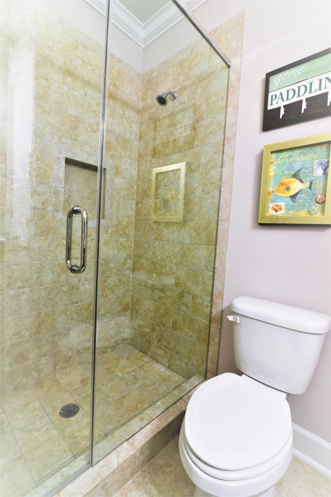 257 Driftwood Road, Unit 2 Miramar Beach, FL 32550 - Photo 33 of 41 a white toilet next to a bathroom shower
