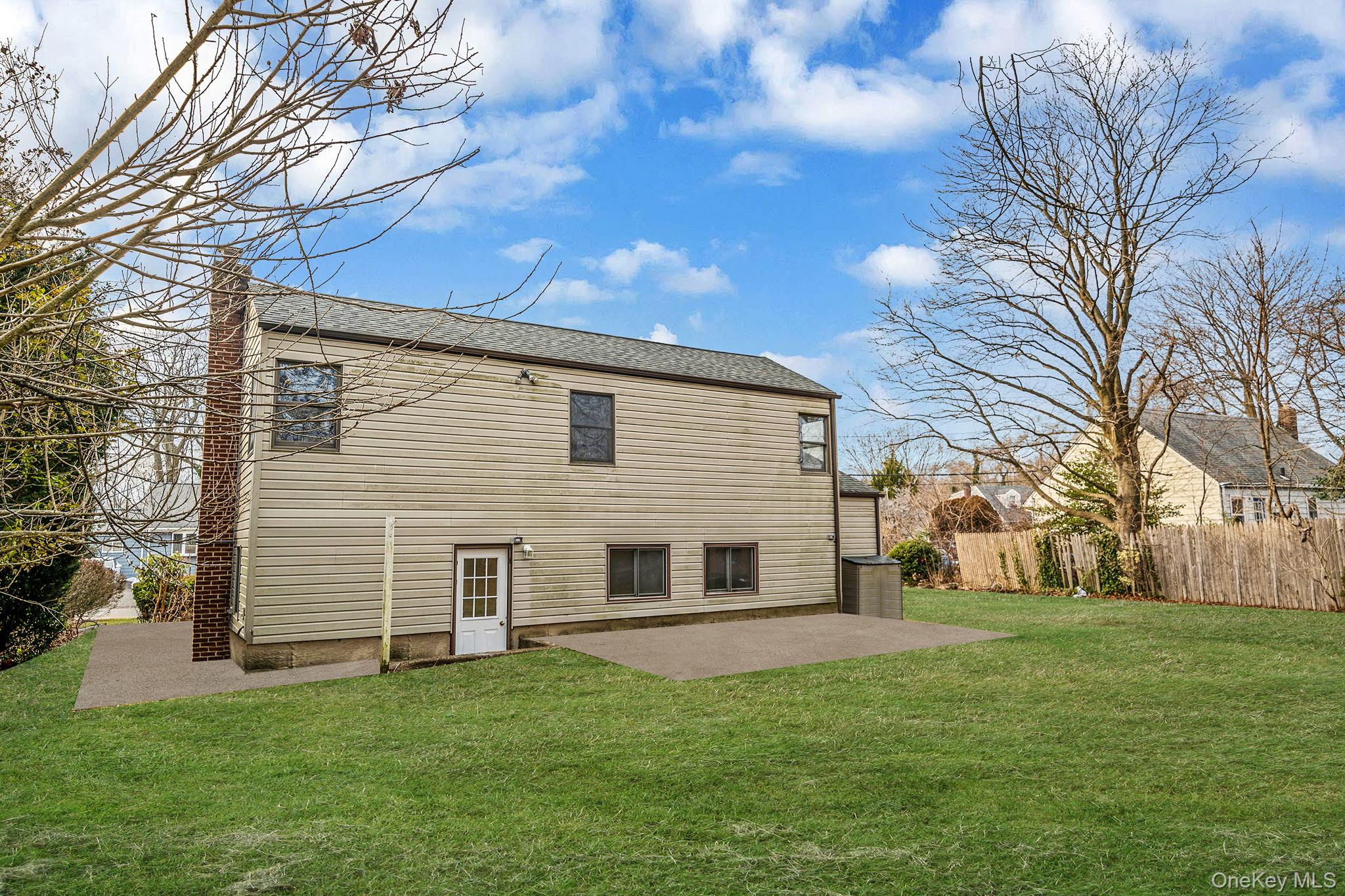 119 Foster Road Ronkonkoma, NY 11779 - Photo 4 of 26 Back of house with a patio area
