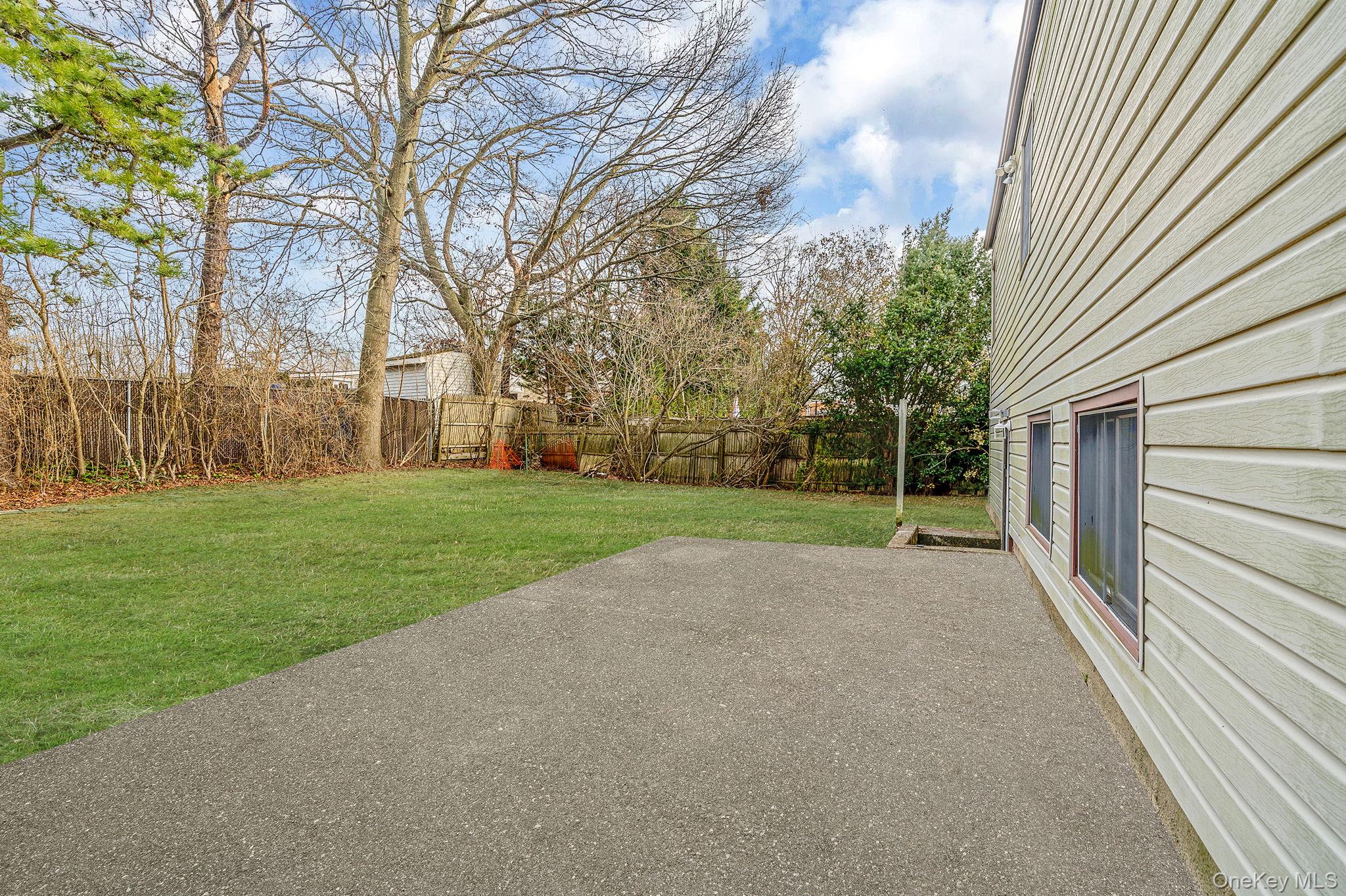119 Foster Road Ronkonkoma, NY 11779 - Photo 7 of 26 Fenced backyard featuring a patio