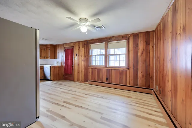 a large kitchen with stainless steel appliances granite countertop a stove cabinets and wooden floor