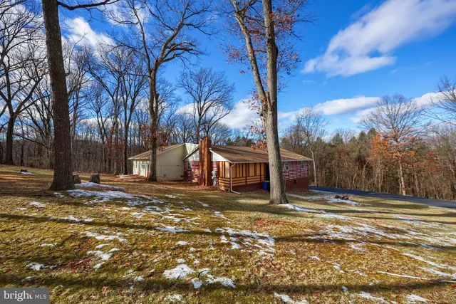 a view of a house with a yard covered in snow