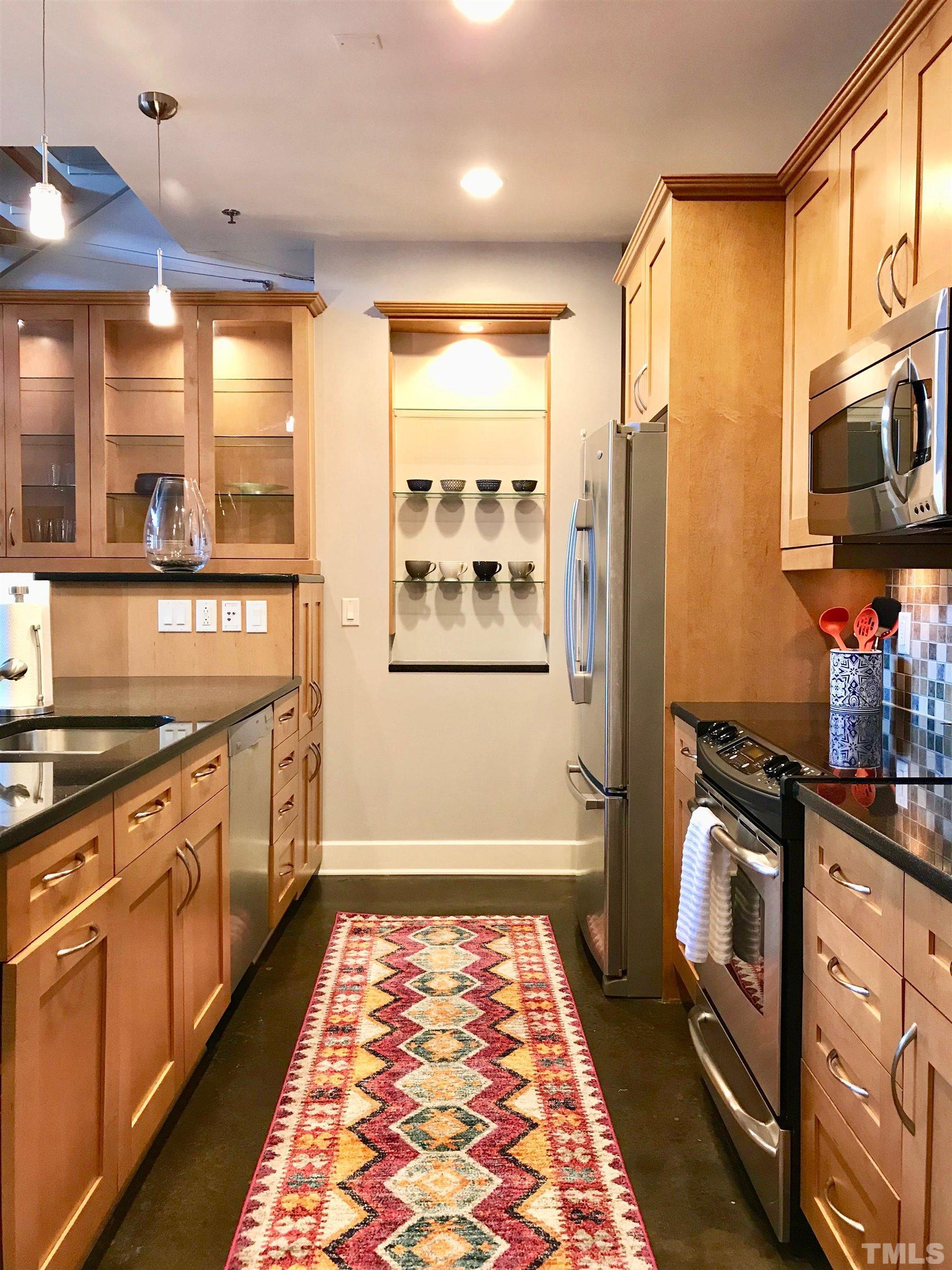 2608 Erwin Road, Unit 417 Durham, NC 27705 - Photo 5 of 39 a kitchen with stainless steel appliances granite countertop a refrigerator a stove and a sink with wooden floor