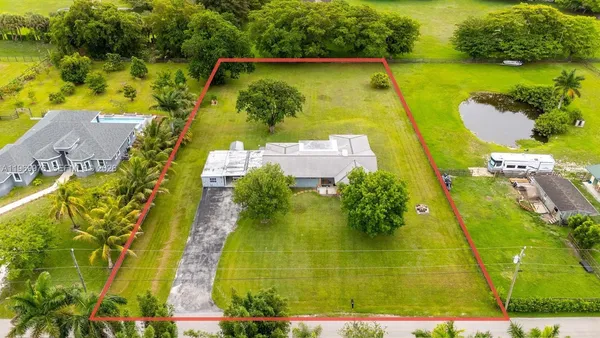 an aerial view of a swimming pool with outdoor seating