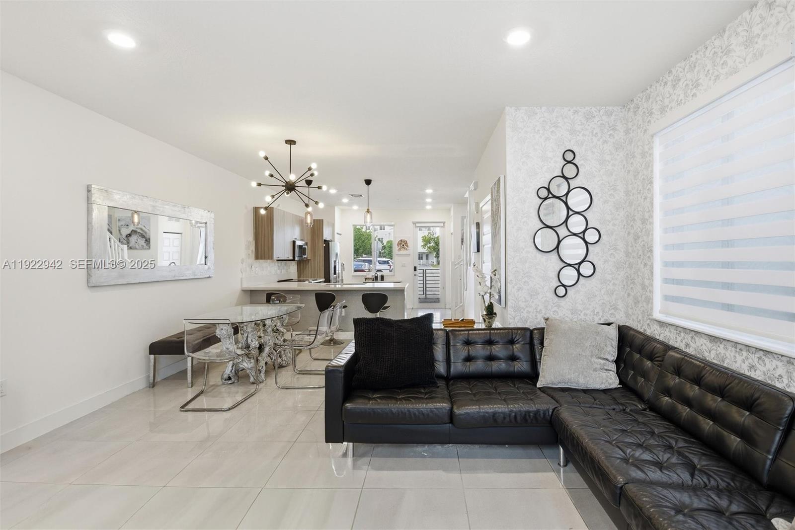 6420 Northwest 102nd Path, Unit 110 Doral, FL 33178 - Photo 16 of 47 a living room with furniture and a chandelier