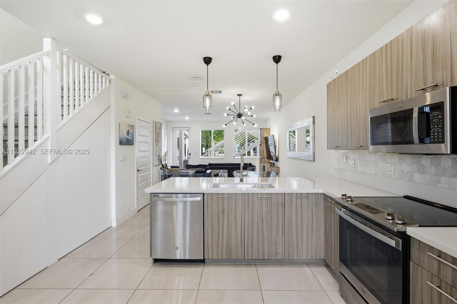 6420 Northwest 102nd Path, Unit 110 Doral, FL 33178 - Photo 18 of 47 a kitchen with stainless steel appliances granite countertop a stove and a sink