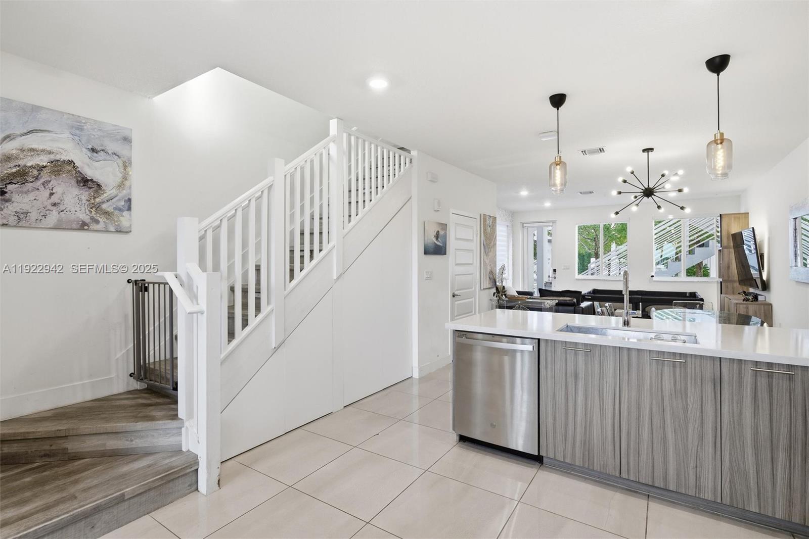 6420 Northwest 102nd Path, Unit 110 Doral, FL 33178 - Photo 19 of 47 a kitchen with kitchen island granite countertop a sink a counter top space and cabinets