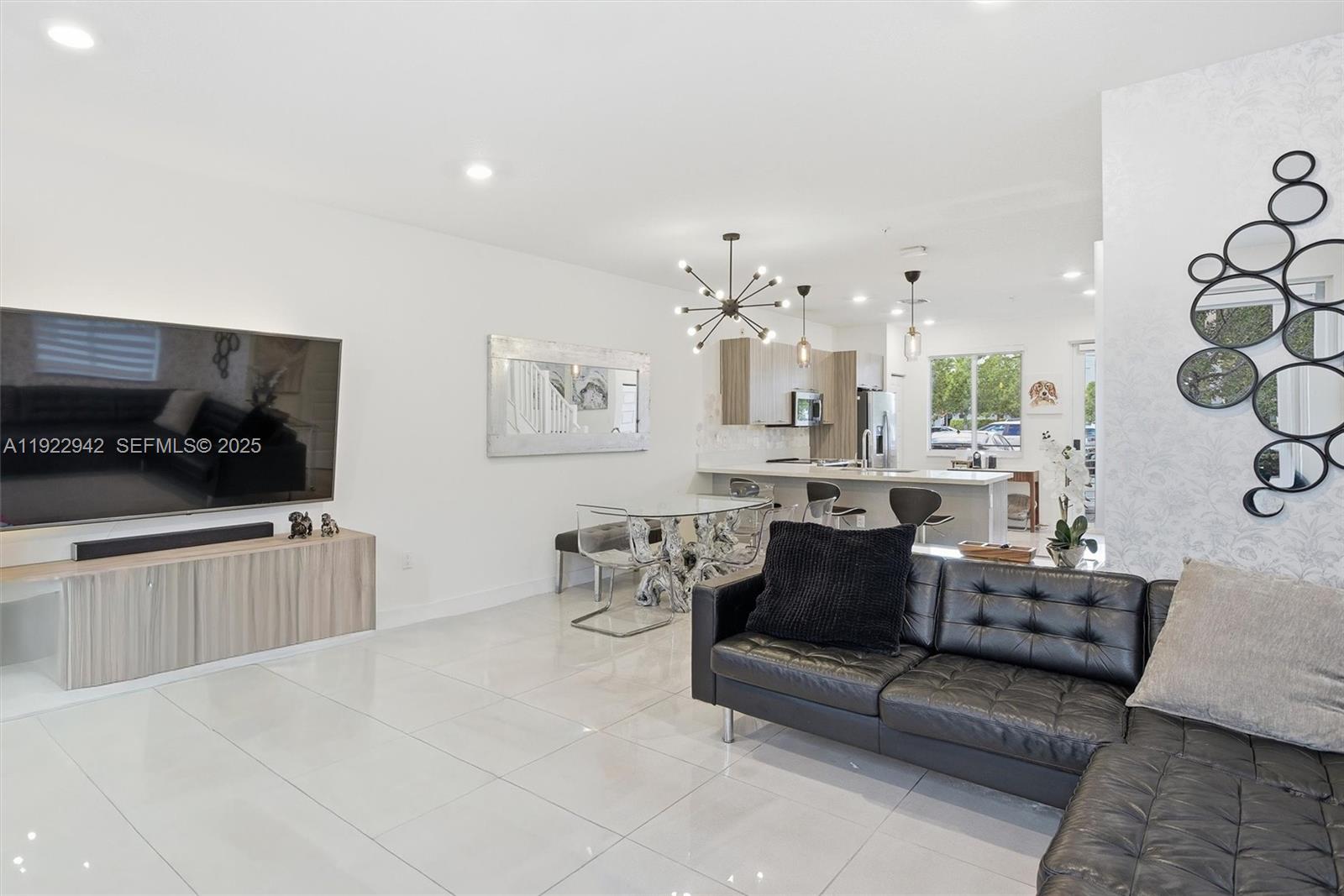 6420 Northwest 102nd Path, Unit 110 Doral, FL 33178 - Photo 2 of 47 a living room with furniture and a flat screen tv