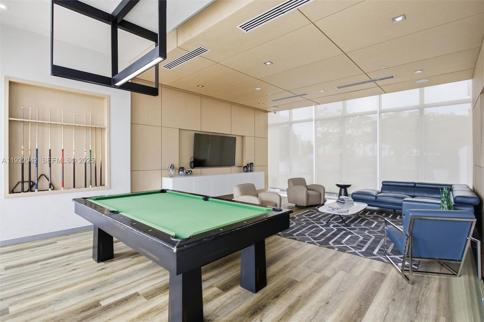 6420 Northwest 102nd Path, Unit 110 Doral, FL 33178 - Photo 32 of 47 a room with furniture pool table and flat screen tv