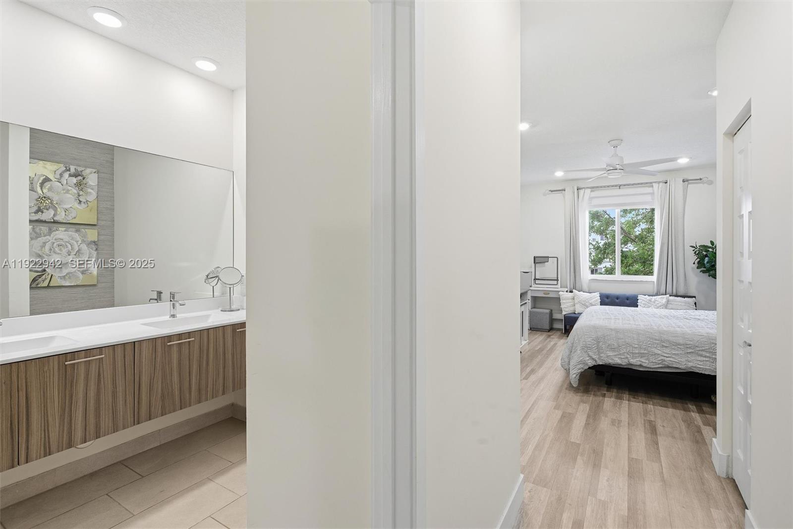 6420 Northwest 102nd Path, Unit 110 Doral, FL 33178 - Photo 5 of 47 a en suite bathroom with a double vanity sink and a mirror