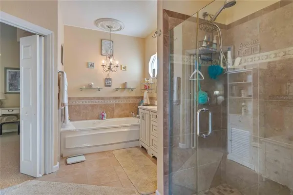 a bathroom with a granite countertop shower a sink and a mirror