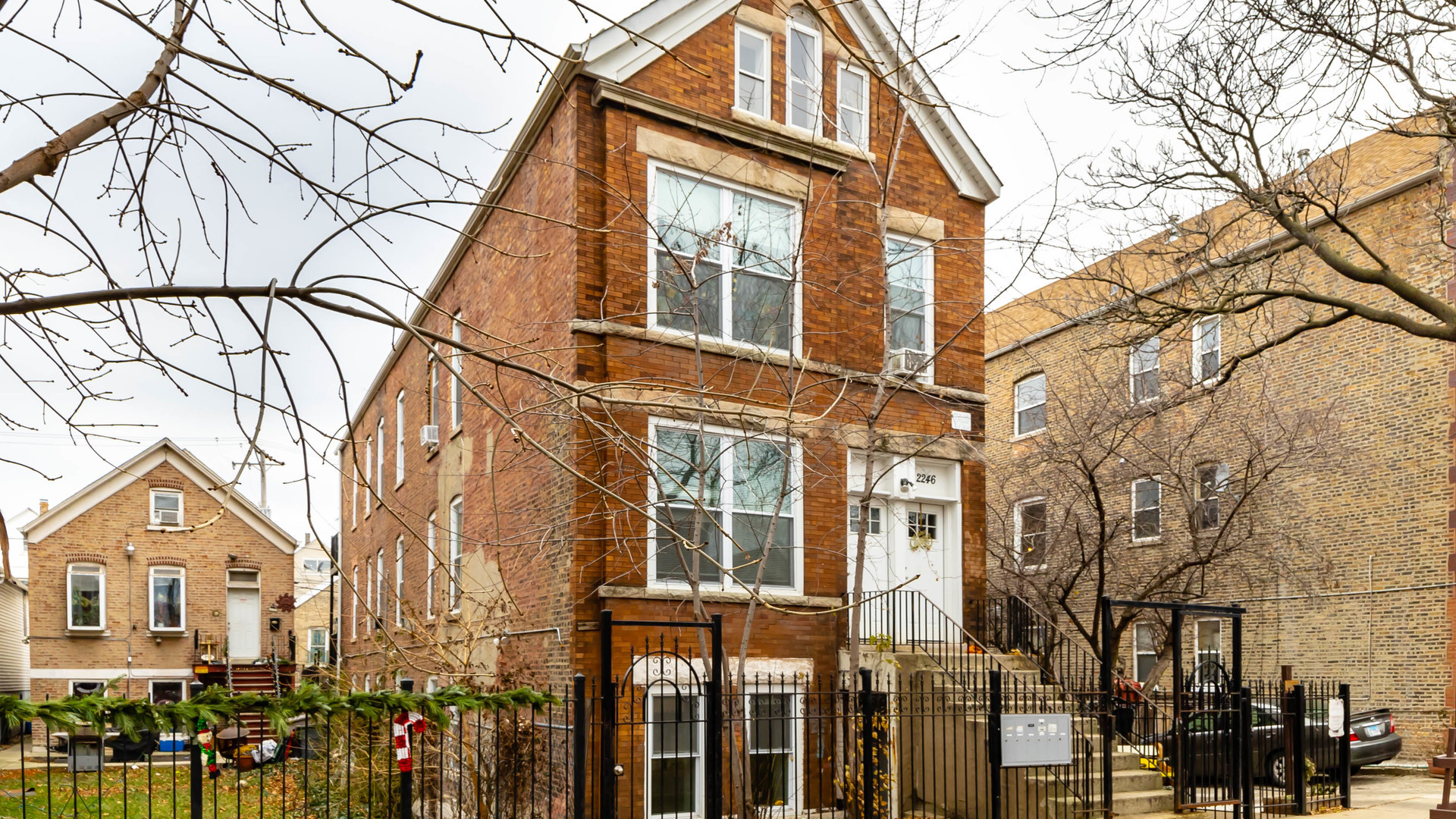 2246 South Whipple Street, Unit 2F Chicago, IL 60623 - Photo 1 of 10 a front view of a residential apartment building with a yard