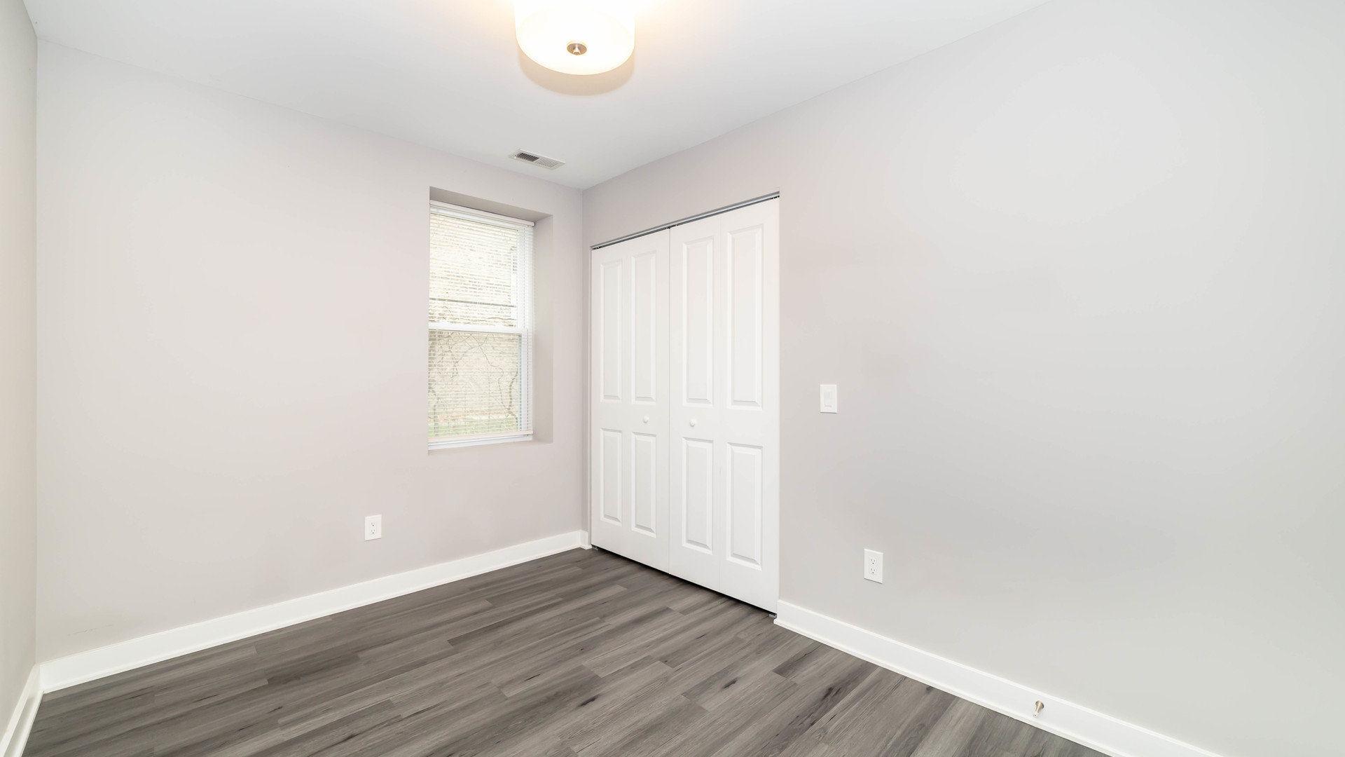 2246 South Whipple Street, Unit 2F Chicago, IL 60623 - Photo 6 of 10 a view of an empty room with wooden floor and a window