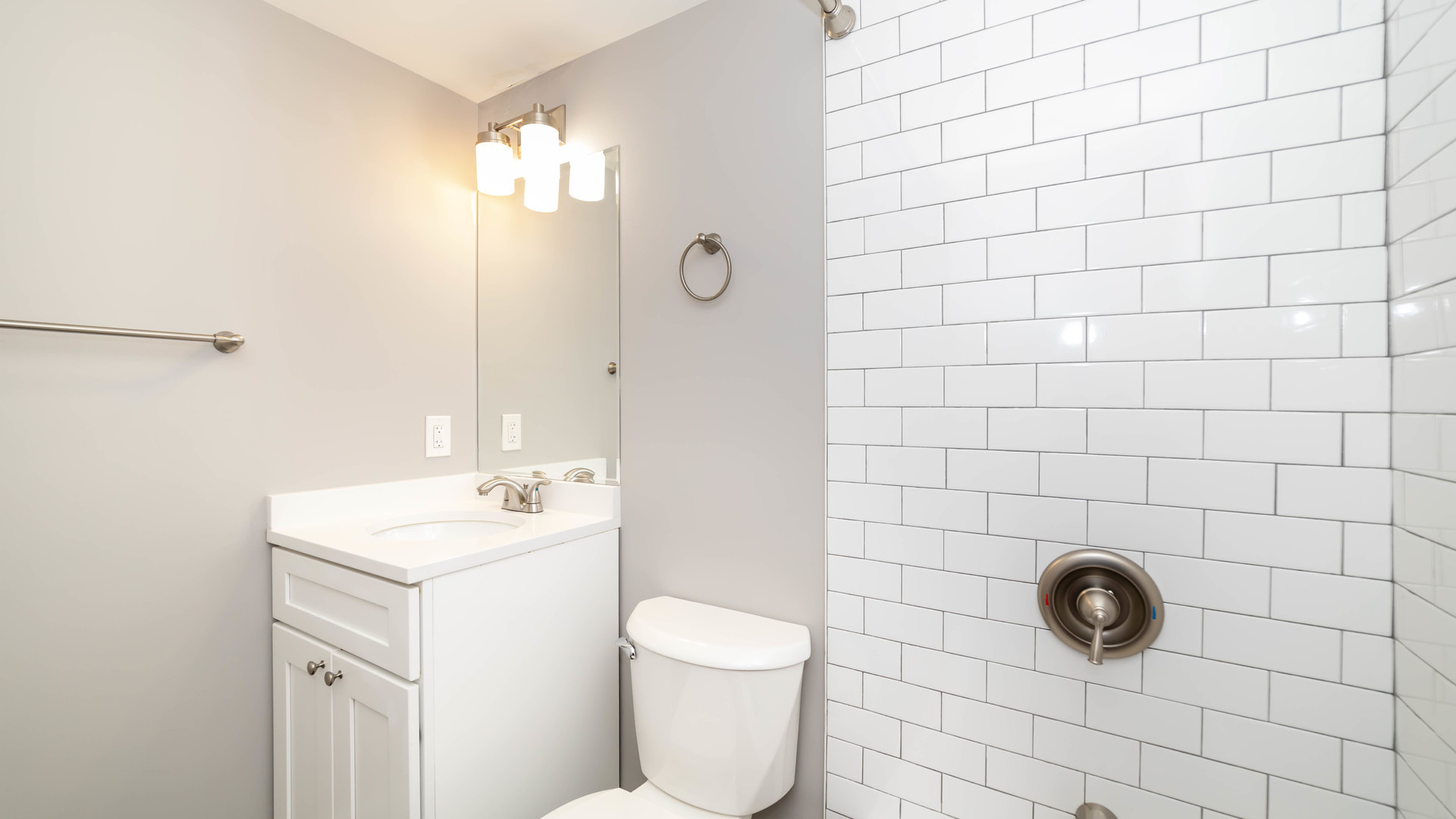 2246 South Whipple Street, Unit 2F Chicago, IL 60623 - Photo 9 of 10 a bathroom with a sink a toilet and mirror