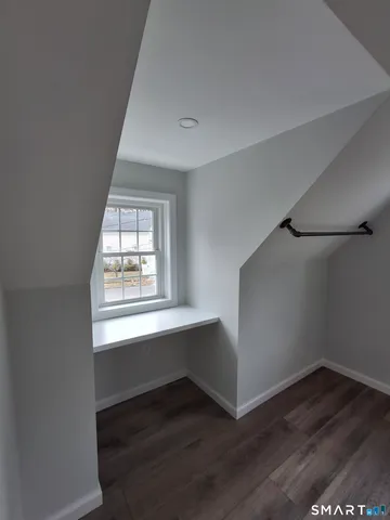 a view of an empty room and wooden floor