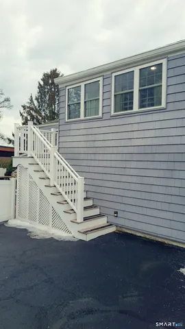 a view of balcony with wooden floor and fence